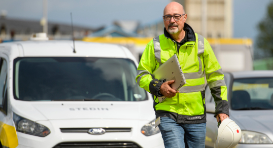 Stedin-medewerker met laptop onder de arm